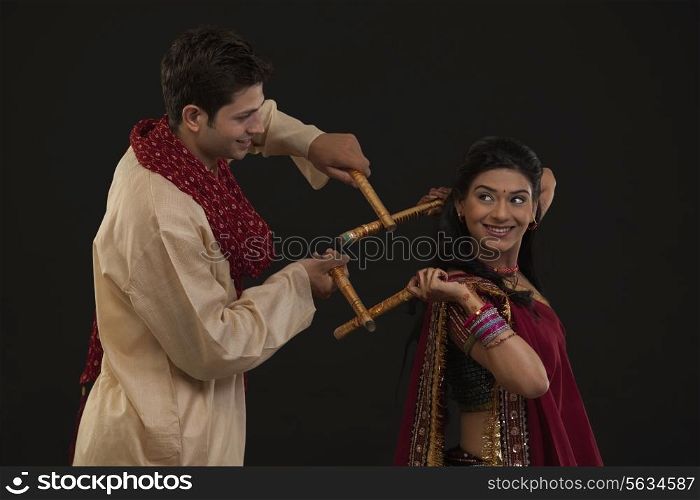 Couple with sticks dancing