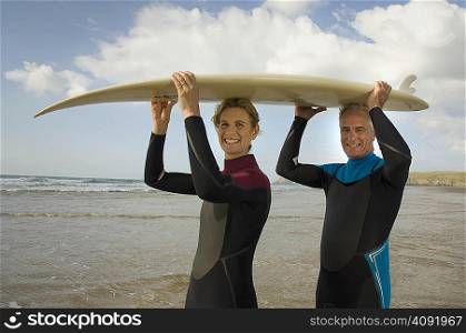 Couple with surfboard on a beach