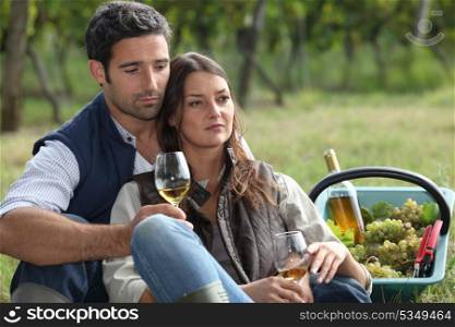 Couple with wine glass in the field