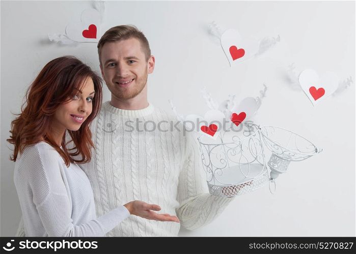 Couple with winged hearts. Young couple with winged hearts flying from the cage, Valentines day concept
