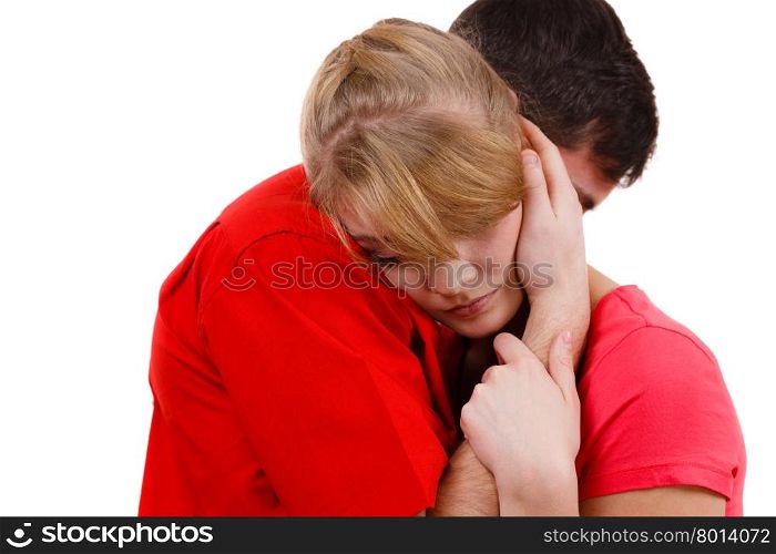 Couple. Woman is sad and being consoled by his partner . Couple hugging. Woman is sad and being consoled by his partner. Man comforting his girlfriend. Troubled girl and her boyfriend. Studio shot on white