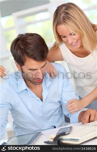 Couple working at home with electronic tablet