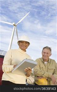 Couple working at wind farm