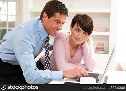 Couple Working From Home Using Laptop