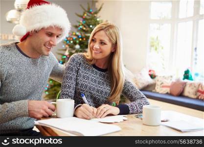 Couple Writing Christmas Cards Together