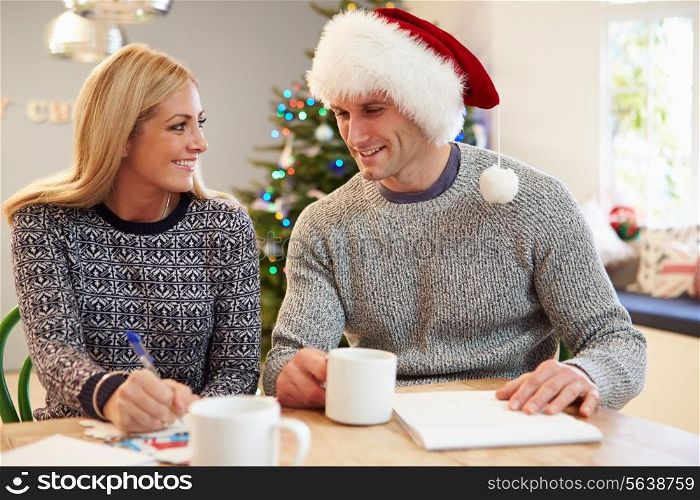 Couple Writing Christmas Cards Together