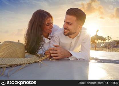 Couple young on beach lounge sunset vacation