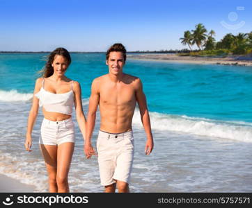 couple young tourists walking in a tropical Caribbean beach in Mexico photo mount