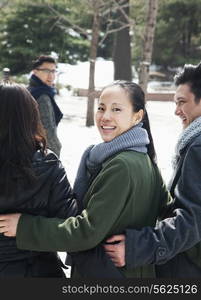 Couples in park covered in snow