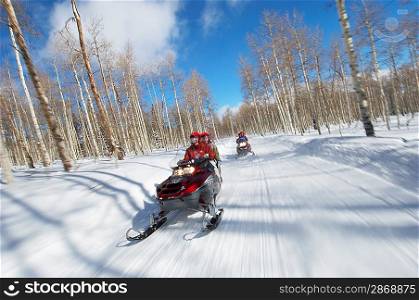 Couples Racing on Snowmobiles