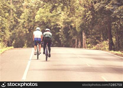 couples riding bicycle on mountain road