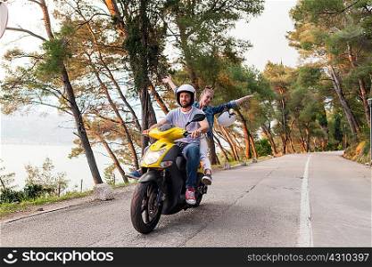 Couples riding moped on rural road, Split, Dalmatia, Croatia