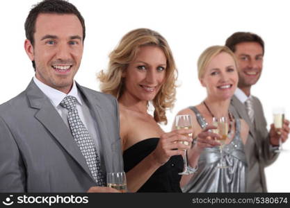 couples standing holding champagne