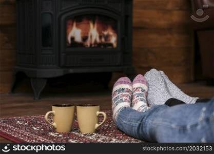 couples warming feet fireplace