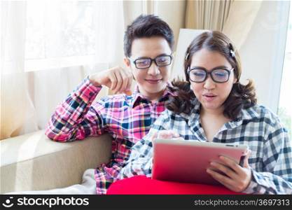Couples with a tablet computer in living room
