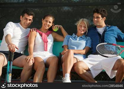 Couples with Tennis Rackets and Balls