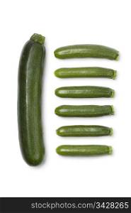 Courgette and mini courgettes on white background