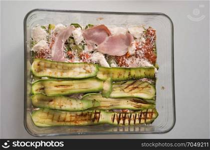 courgettes aka zucchini vegetables food. courgettes (Cucurbita pepo) aka zucchini grilled vegetables with tomato and cheese and ham