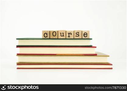 course word on wood stamps stack on books, knowledge and academic concept