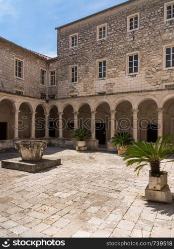 Courtyard in the Franciscan Monastery in the ancient old town of Zadar in Croatia. Cloisters of Franciscan Monastery in the old town of Zadar in Croatia