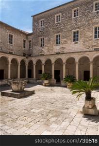 Courtyard in the Franciscan Monastery in the ancient old town of Zadar in Croatia. Cloisters of Franciscan Monastery in the old town of Zadar in Croatia