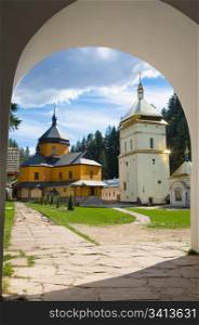 Courtyard of christian monastery (Manjava village, Ivano-Frankivsk Region, Ukraine) view through the entrance gate arch