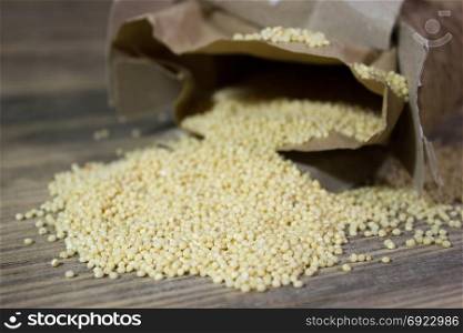 Couscous for a healthy diet on wooden background