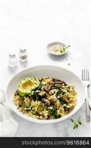 Couscous with avocado, spinach and sauteed ch&ignon mushrooms with onion