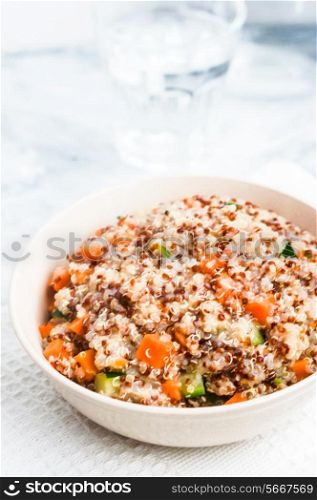 Couscous with vegetables on wooden background