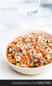 Couscous with vegetables on wooden background