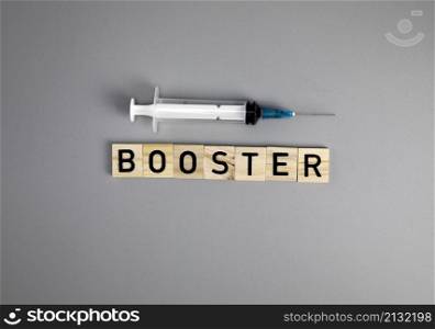 Covid-19 booster shots vaccine text on Gray background Covid-19 booster shots, with syringe top view and copy space , medical health,pandemic and vaccine concept. space for text. Covid-19 booster shots vaccine text on Gray background Covid-19 booster shots, with syringe top view and copy space , medical health,pandemic and vaccine concept.