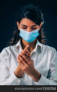 Covid-19 Coronavirus Outbreak Prevention. Beautiful Young Woman Disinfecting her Hands, Using Hand Sanitizer Gel