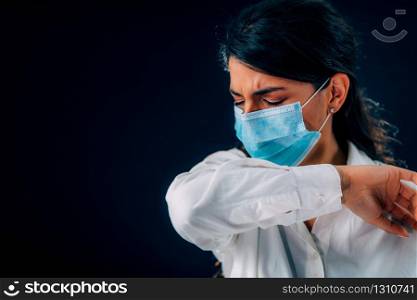 Covid-19 Coronavirus Prevention. Beautiful Young Woman Coughing in her Elbow or Sleeve