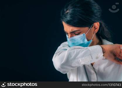 Covid-19 Coronavirus Prevention. Beautiful Young Woman Coughing in her Elbow or Sleeve