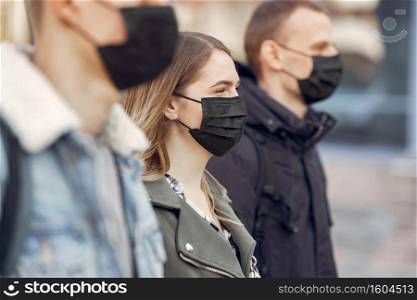 Covid-19, health and social distancing concept. Attractive brunette girl in medical mask pointing finger at face, white background.. Covid-19, health and social distancing concept. Attractive brunette girl in medical mask pointing finger at face, white background