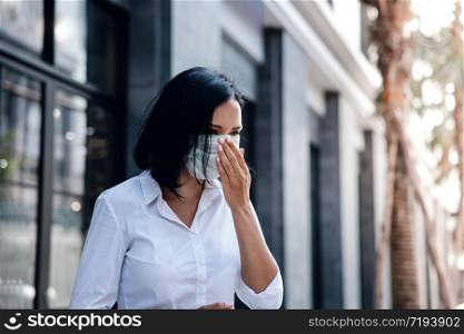 Covid-19 or Corona Virus or Air Pollution PM2.5 Situation Concept. Young Woman with Medical Mask Coughing in Public Outdoor
