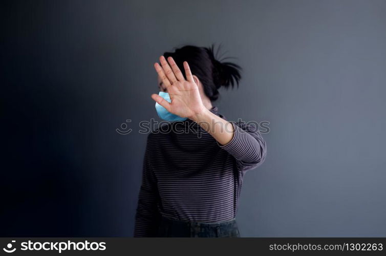 Covid-19 or Corona Virus Situation Concept. Young Woman with Medical Mask Keeping her Personal Clean Zone by Stop Sign Gesture Hand