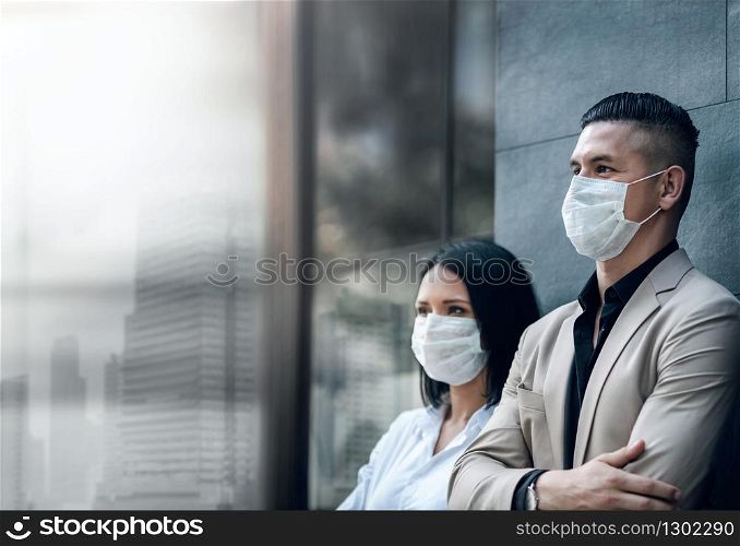 Covid-19 or Corona Virus Situation in Business Concept. Businessman and Woman with Medical Mask Looking away Outside the Office Building. Vision to Deal with it