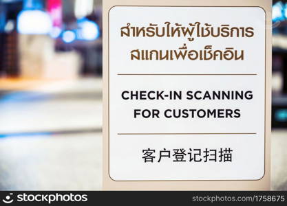 Covid-19 pandemic, new normal Concept, Check-in Scanning for customer text with Thai and Chinese Language on the Billboard before walking in department store