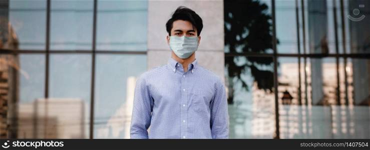 Covid-19 Situation in Business Concept. Businessman with Surgical Mask standing in the City. Protected and Care of Health. Stressed out due to Corona Virus. Looking at Camera