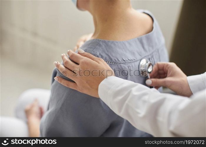 covid recovery center female doctor checking elder patient with stethoscope. High resolution photo. covid recovery center female doctor checking elder patient with stethoscope. High quality photo