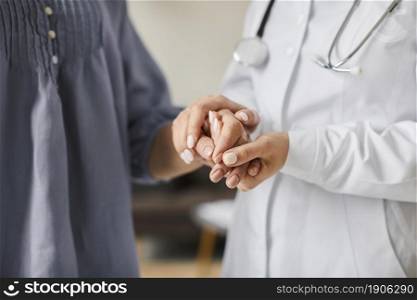 covid recovery center female doctor holding elderly patient s hands. High resolution photo. covid recovery center female doctor holding elderly patient s hands. High quality photo