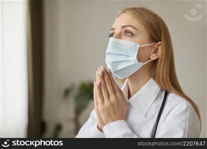 covid recovery center female doctor with stethoscope medical mask praying