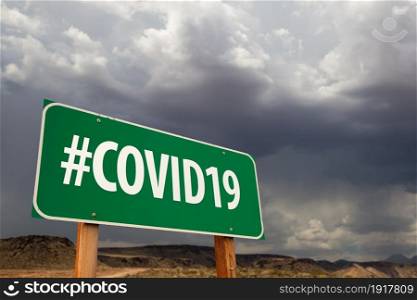 #COVID19 Green Road Sign Against An Ominous Cloudy Sky.