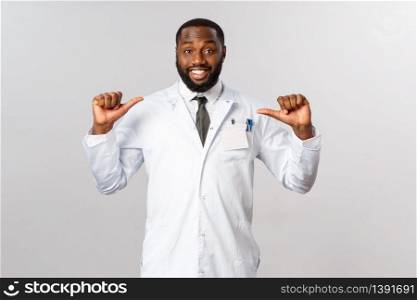 Covid19, healthcare and clinic concept. I am specialist and professional you looking for. Upbeat african-american male doctor pointing at himself and smiling, ask me anything, contact your physician.. Covid19, healthcare and clinic concept. I am specialist and professional you looking for. Upbeat african-american male doctor pointing at himself and smiling, ask me anything, contact your physician