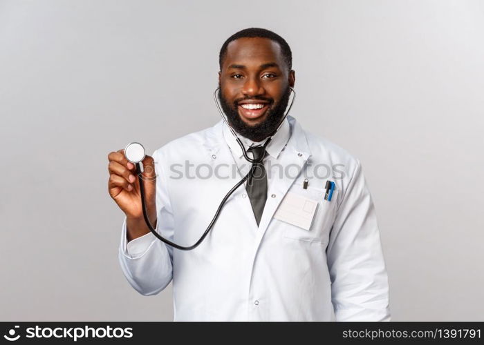 Covid19, hospital check-up and healthcare concept. Handsome african-american doctor, physician came to patient with stethoscope treating coronavirus symptoms with lungs, breathing capacity.. Covid19, hospital check-up and healthcare concept. Handsome african-american doctor, physician came to patient with stethoscope treating coronavirus symptoms with lungs, breathing capacity