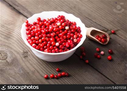 Cowberry in the bowl on the table
