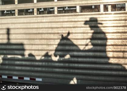Cowboy Cowgirl Equestrian Rider Shadow on Horse Trailer Corigated Metal Evening Light