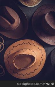 cowboy hat at table wooden background, top view