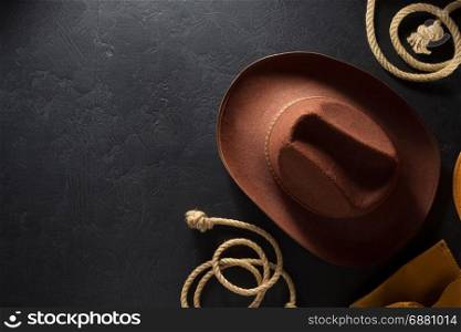 cowboy hat on black wooden background